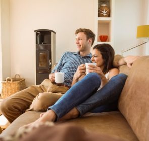 Couple enjoying the warmth of a combi boiler at home, warm and cozy