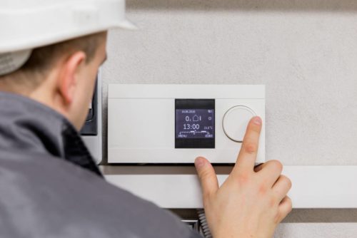 Heating engineer repairing a boiler