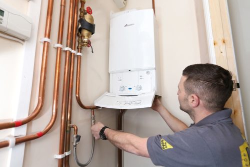 Engineer installing a boiler; boiler installation cost